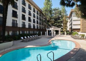 a swimming pool in front of a building at Hilton Stockton in Stockton