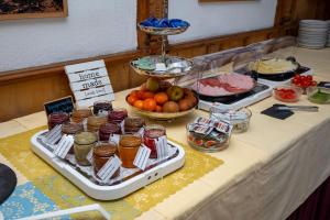 a table with a buffet of food on it at Hotel Heimgartl in Innsbruck