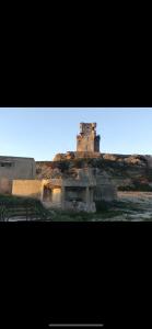 an old building on top of a hill at TURISMO LOS LANCES TARIFA( PARKING GRATUITO) in Tarifa