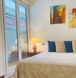 a bedroom with a bed and a large window at KARRAKELLA apartamentua con aire in Orio