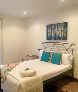 a bedroom with a bed with blue and white pillows at KARRAKELLA apartamentua con aire in Orio