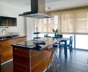 a kitchen with a large island with a table and chairs at KARRAKELLA apartamentua con aire in Orio