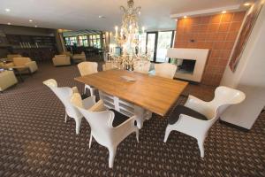 a dining room with a table and white chairs at Best Western Smart Hotel in Vösendorf