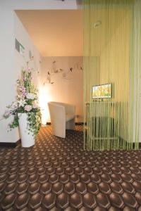 a bathroom with a toilet and flowers in a room at Best Western Smart Hotel in Vösendorf