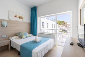 Postel nebo postele na pokoji v ubytování Hostal Neptuno