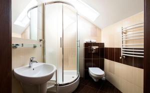 a bathroom with a sink and a shower and a toilet at Willa JANTAR in Dębki +56 photos