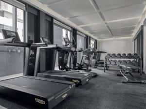 a gym with several treadmills and cardio machines at Mercure ICON Singapore City Centre in Singapore
