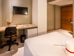 Cama ou camas em um quarto em ibis Styles Belém do Pará