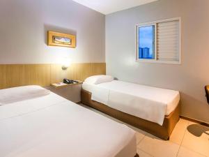 Cama ou camas em um quarto em ibis Styles Belém do Pará
