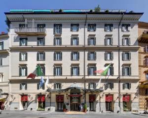 a large white building with flags in front of it at Hotel Splendide Royal - The Leading Hotels of the World in Rome