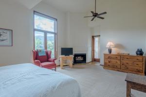 1 dormitorio con 1 cama, 1 silla y chimenea en Summit Condo 2815 en Elkhorn Village