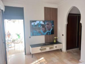 Belle Vue في مراكش: غرفة معيشة مع تلفزيون بشاشة مسطحة على جدار