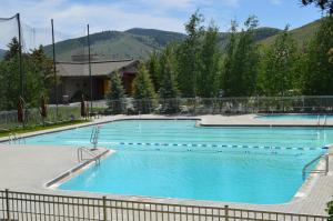 two large swimming pools with mountains in the background at Summit Condo 2815 in Elkhorn Village