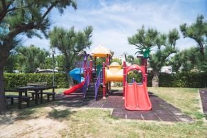 a playground with a slide in a park at Club del Sole Le Mimose Family Resort in Porto SantʼElpidio