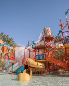a water park with a water slide in the water at Grand Waterworld Makadi Family Star - Couples and Families Only in Hurghada