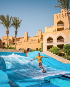 een man op een waterglijbaan in een resort bij Grand Waterworld Makadi Family Star - Couples and Families Only in Hurghada