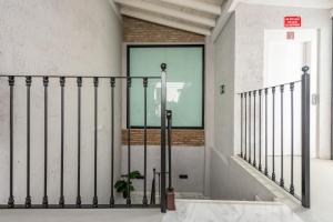 een trap met een zwarte metalen reling in een gebouw bij Málaga Boutique Adults Recommended in Málaga
