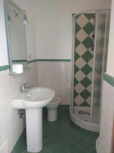 a bathroom with a sink and a shower and a toilet at B&B vacanze Mille Colori in Cinisi