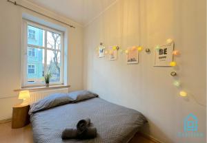 a small bedroom with a bed and a window at Butterfly Room in Gdańsk
