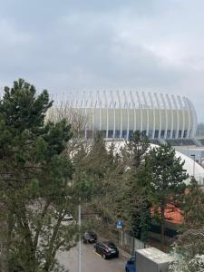 a soccer stadium with cars parked in front of it at Hostel Arena in Zagreb