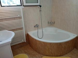 a bathroom with a large tub and a sink at Panormos Serene Nests - Gateways to Achaia in Psathopirgos