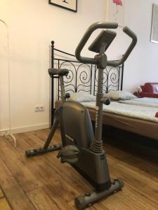 a exercise bike on the floor next to a bed at Apart 3b in Krakow