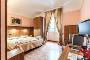 a hotel room with a bed and a desk at Hotel Altavilla in Rome