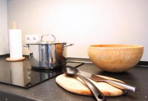 a counter with two spoons and a pot and a bowl at Apartamento Marques de Zafra - Ventas in Madrid