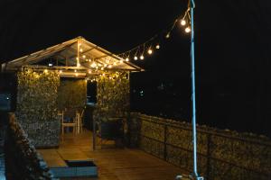 a deck with a tent with lights at night at Pontonul de pe Dunăre Giurgiu in Giurgiu
