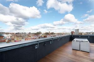 a balcony with a view of a city at Modern Serviced 3-bedroom flat in East London in London