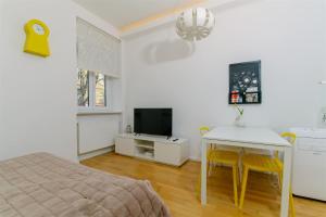 a bedroom with a bed and a table and a television at Tia Studio in Zagreb