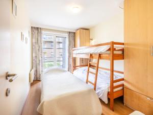 1 dormitorio con 2 literas y ventana en Parnasse with a central location, en Koksijde