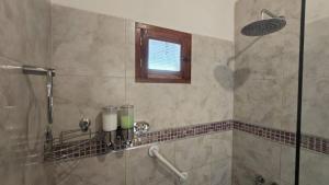 a bathroom with a shower with a window at El cielo en Purmamarca Duplex 3 in Purmamarca
