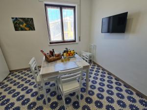 a dining room table with a bowl of fruit on it at CASA BETANIA DA PEPPE in Sorrento