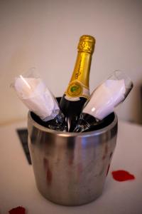 a bottle of champagne in a bucket on a table at Motel Paraíso do Braseiro in Vila Nova de Gaia