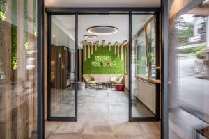 an entrance to a hotel lobby with glass doors at Hotel Val Di Sole in Mezzana