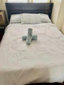 a white bed with two towels on it at 1bedroom Condo For rent with WiFi pool and gym in Cebu City