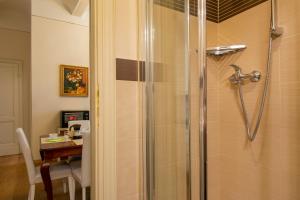 a bathroom with a shower with a table and a dining room at Casa Michelangelo & Giotto - Tintori apt in Florence +35 photos