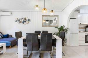 a living room with a dining room table and chairs at HE Paola 2 in Orihuela Costa