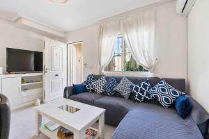 a living room with a couch and a table at HE Paola 2 in Orihuela Costa