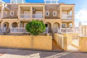 a large yellow house with a white fence in front of it at HE Paola 2 in Orihuela Costa