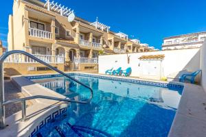 a swimming pool in front of a building at HE Paola 2 in Orihuela Costa