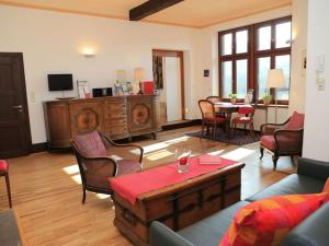 a living room with a couch and a table at Apartment Pinot Noir in Niederheimbach