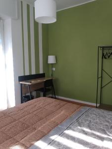 a bedroom with a bed and a desk with a lamp at Stanza indipendente a Gallarate in Gallarate