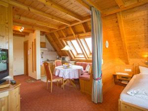 a dining room with a table and a room with at Holiday apartment Morning Sun in Hinterzarten
