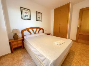 A bed or beds in a room at Apartamentos Daytona-Galicia 3000