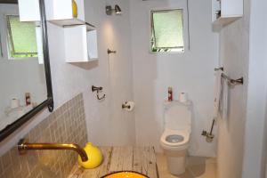 a small bathroom with a toilet and a sink at Sabie River Bush Lodge in Hazyview