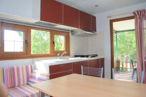 a kitchen with a sink and a counter top at Camping Village Stella Mare in Lacona