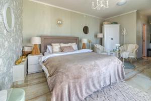 a bedroom with a large bed and a table and chairs at Bungalow Lux 2 in Novi Banovci