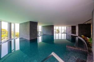 a swimming pool with blue water in a building at Breathtaking Studio - Al Jaddaf in Dubai